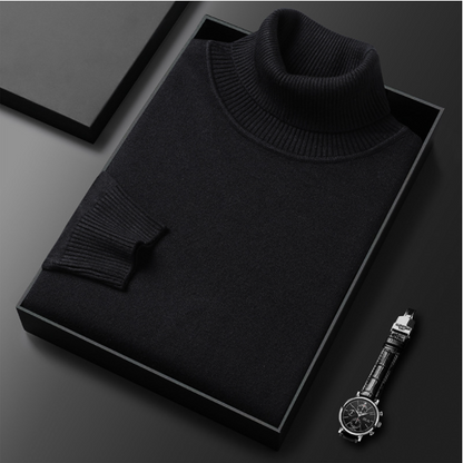 Schwarzer Rollkragenpullover in Geschenkbox auf schwarzem Hintergrund, daneben eine elegante Armbanduhr. Luxuriöse Modeaccessoires für Herren.