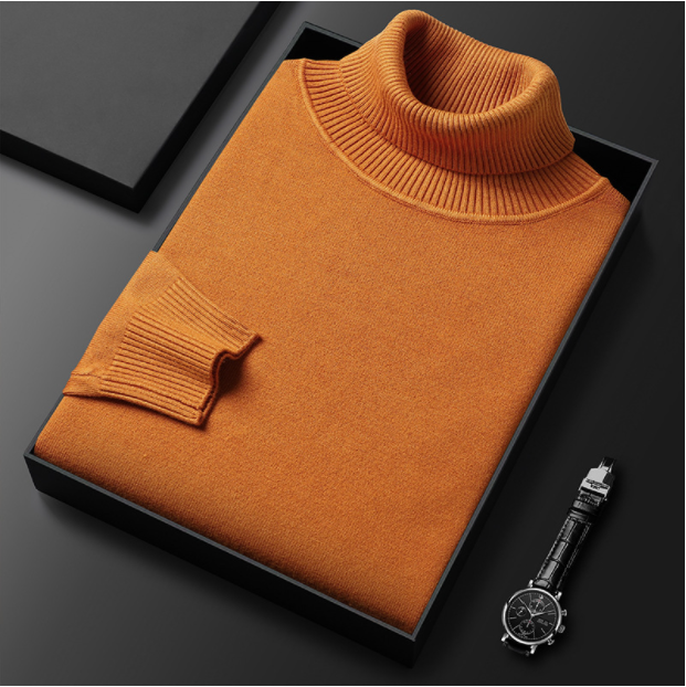 Orangefarbener Rollkragenpullover aus Kaschmir in schwarzer Geschenkbox, daneben eine elegante Armbanduhr. Hochwertige Modeaccessoires.