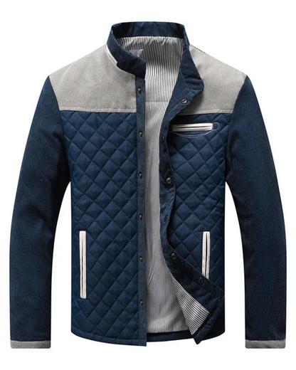 Dunkelblaue Steppjacke mit grauen Schulterpartien, Stehkragen und weißen Akzenten. Modische Herrenjacke, ideal für Herbst und Winter.