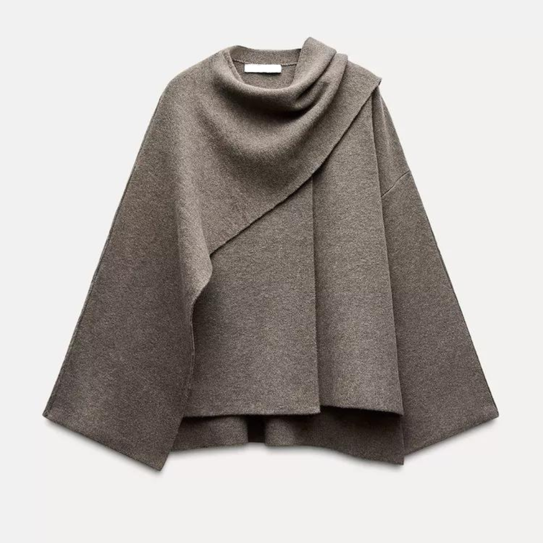 Grauer Damenponcho aus Wolle, asymmetrisches Design, modisches Herbst-Winter-Outfit, eleganter Überwurf, warme Bekleidung, stilvoller Look.