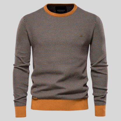 Herrenpullover mit geometrischem Muster, Rundhalsausschnitt und orangefarbenen Bündchen. Modischer Strickpullover für Herbst und Winter.