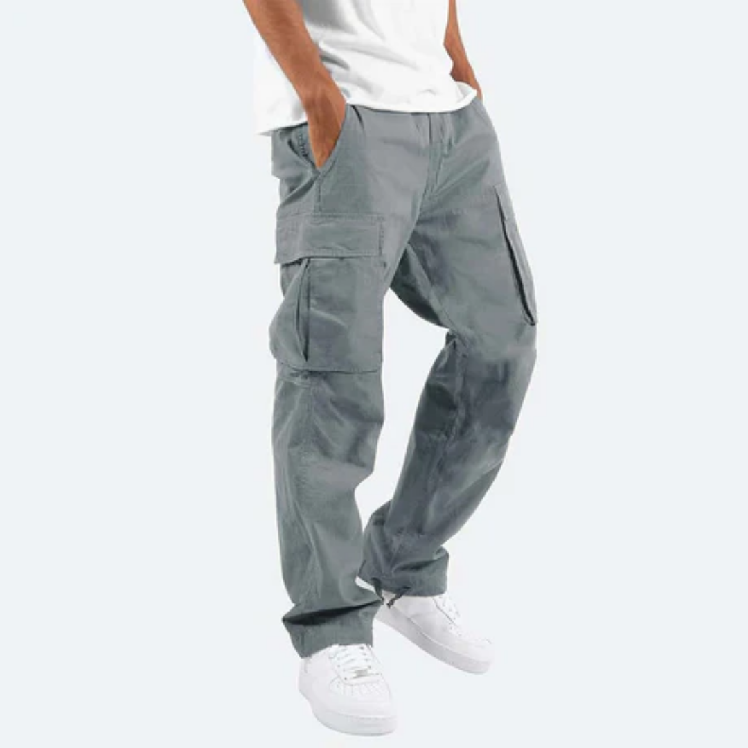 Graue Cargo-Hose für Herren, lässig geschnitten, mit Seitentaschen, kombiniert mit weißen Sneakers und weißem T-Shirt. Ideal für Freizeitmode.