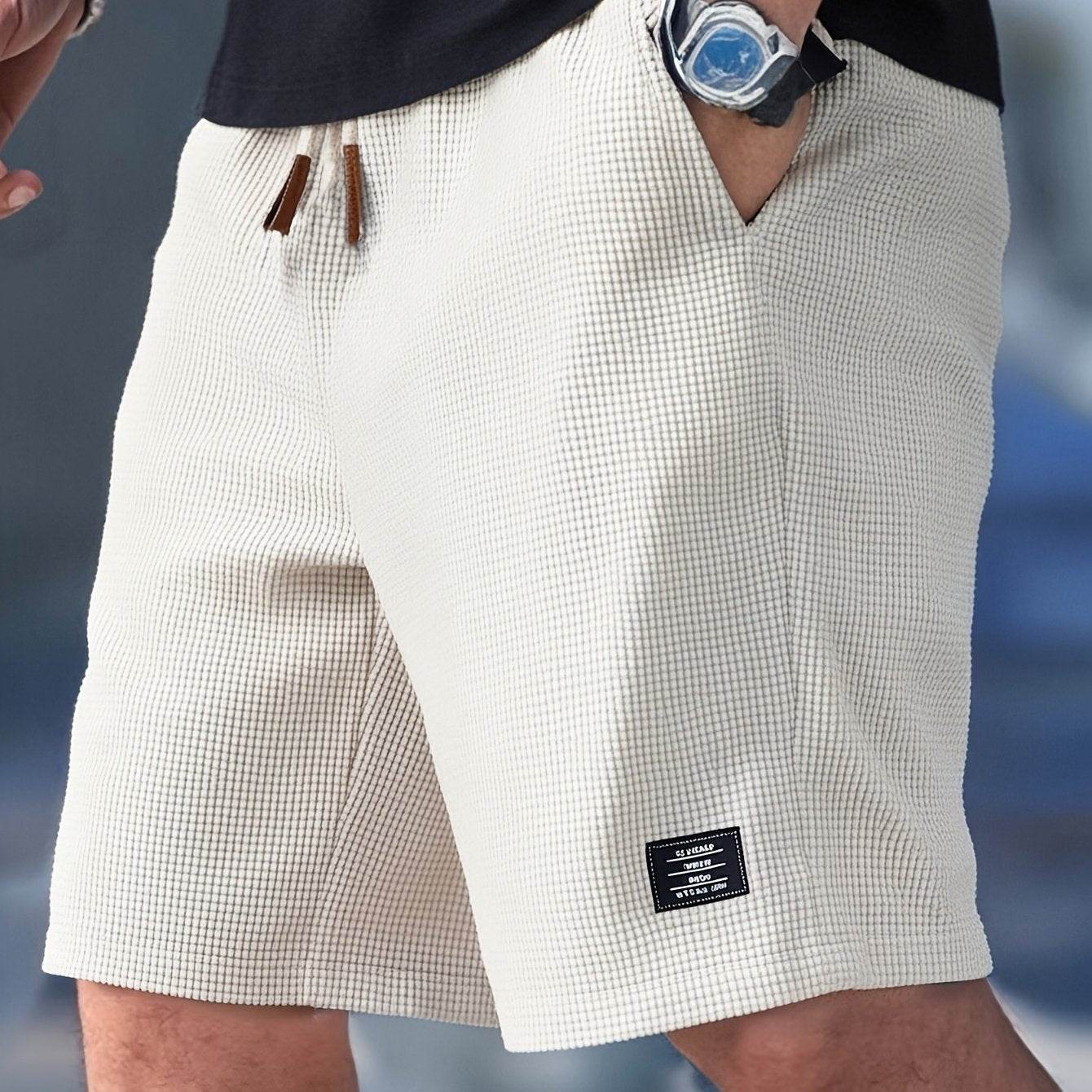 White shorts worn by a person with a watch on a blue background