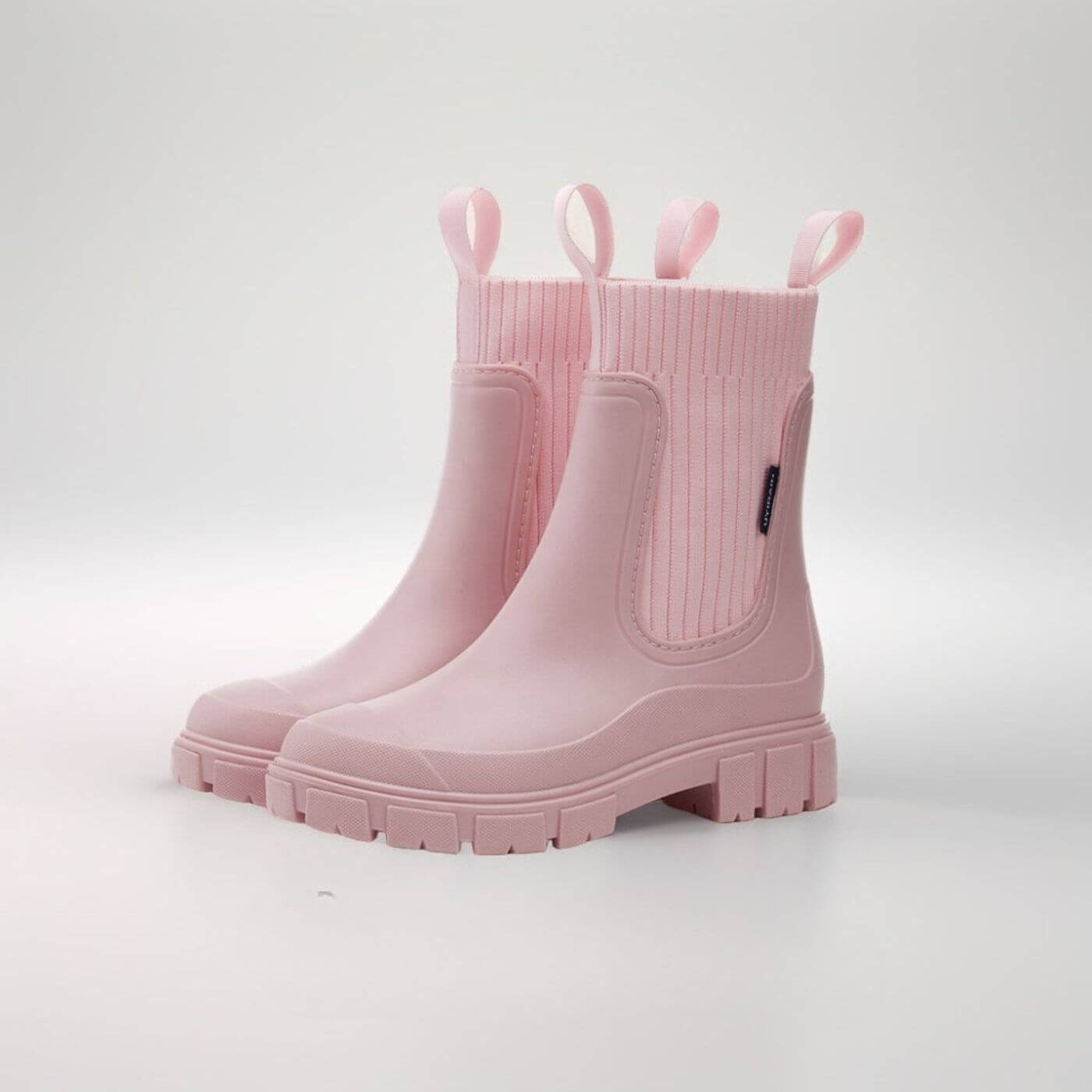 Rosa Gummistiefel mit dicker Sohle und seitlichen Schlaufen, modisch und wetterfest, ideal für Regenwetter und Outdoor-Aktivitäten.