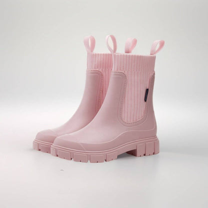Rosa Gummistiefel mit dicker Sohle und seitlichen Schlaufen, modisch und wetterfest, ideal für Regenwetter und Outdoor-Aktivitäten.