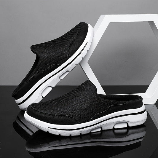 Schwarze Herren-Sneaker ohne Schnürsenkel, atmungsaktiv, mit weißer Sohle, auf schwarzem und grauem Hintergrund, modisch und bequem.